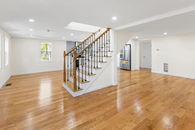 a view of an entryway with wooden floor