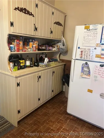 a white refrigerator freezer sitting inside of a kitchen