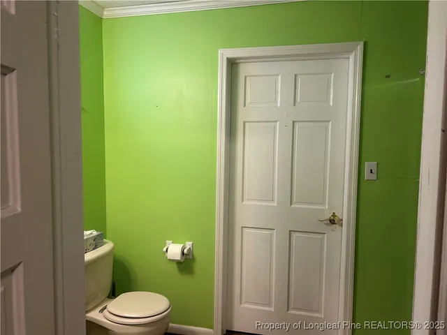 a white toilet sitting next to a bathroom sink