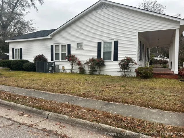 a view of a house with backyard porch and furniture