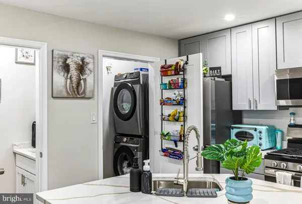 a living room with stainless steel appliances furniture or kitchen and a wooden floor