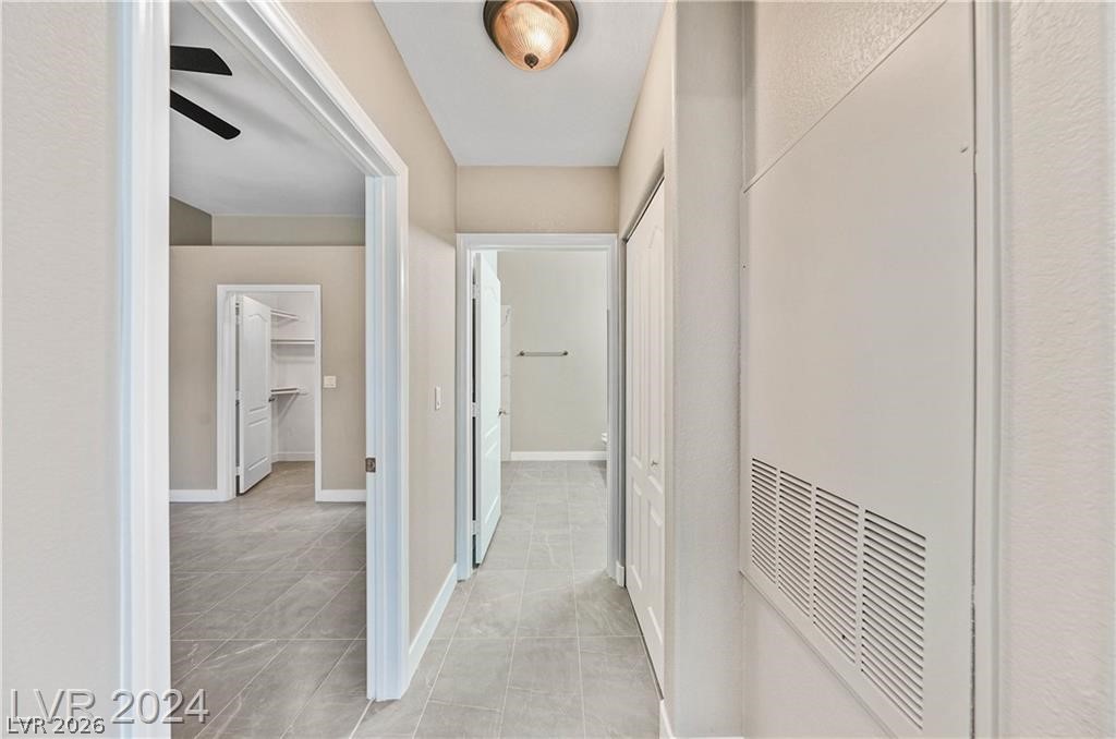 2305 West Horizon Ridge Parkway, Unit 1411 Henderson, NV 89052 - Photo 12 of 17 This interior hallway features sleek tile flooring, providing seamless flow to adjoining rooms.