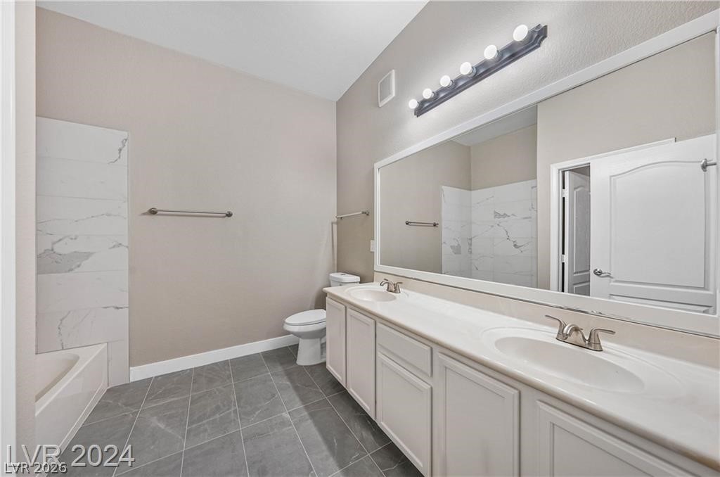 2305 West Horizon Ridge Parkway, Unit 1411 Henderson, NV 89052 - Photo 14 of 17 This spacious bathroom features a double vanity and a shower-tub combination with elegant tile.