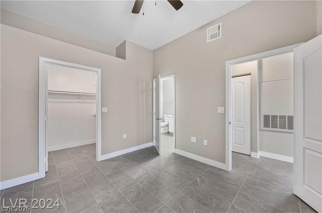 2305 West Horizon Ridge Parkway, Unit 1411 Henderson, NV 89052 - Photo 16 of 17 This versatile bedroom offers an en-suite bathroom and ample closet space, with cool tiled flooring.