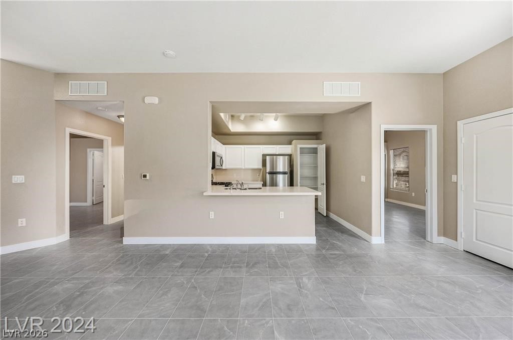 2305 West Horizon Ridge Parkway, Unit 1411 Henderson, NV 89052 - Photo 4 of 17 This bright, open-concept interior features sleek tiled flooring and a functional kitchen with modern appliances.