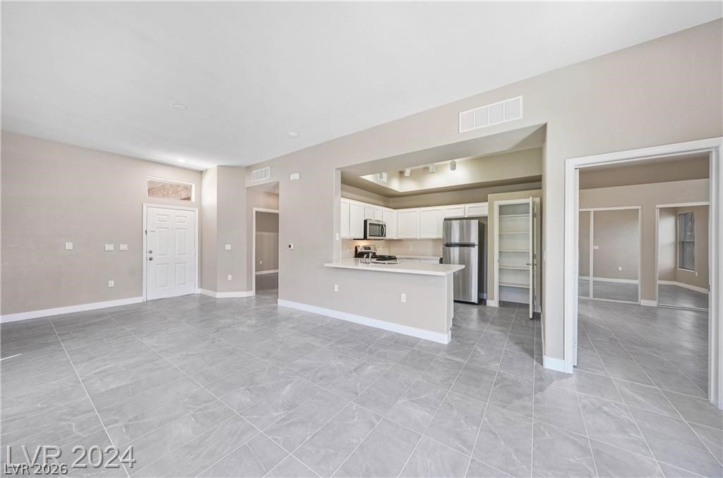 2305 West Horizon Ridge Parkway, Unit 1411 Henderson, NV 89052 - Photo 5 of 17 This versatile open-concept living area seamlessly connects to a contemporary kitchen, perfect for everyday living.