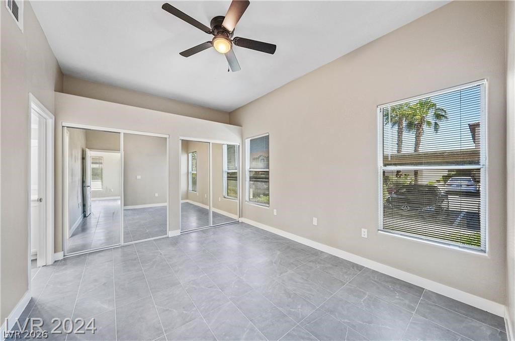 2305 West Horizon Ridge Parkway, Unit 1411 Henderson, NV 89052 - Photo 7 of 17 This airy bedroom features mirrored closets, elegant tiled flooring, and ample natural light.