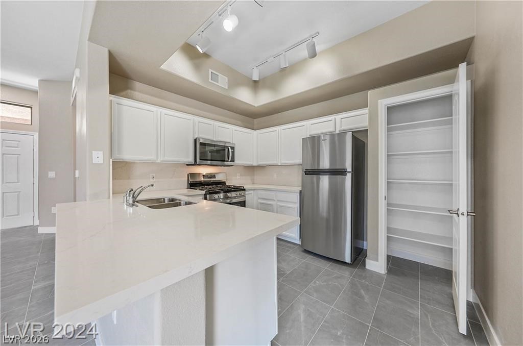2305 West Horizon Ridge Parkway, Unit 1411 Henderson, NV 89052 - Photo 9 of 17 This bright kitchen features sleek appliances, ample counter space, and a convenient pantry.