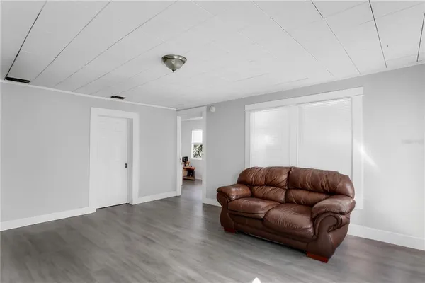 a living room with furniture a couch and a window