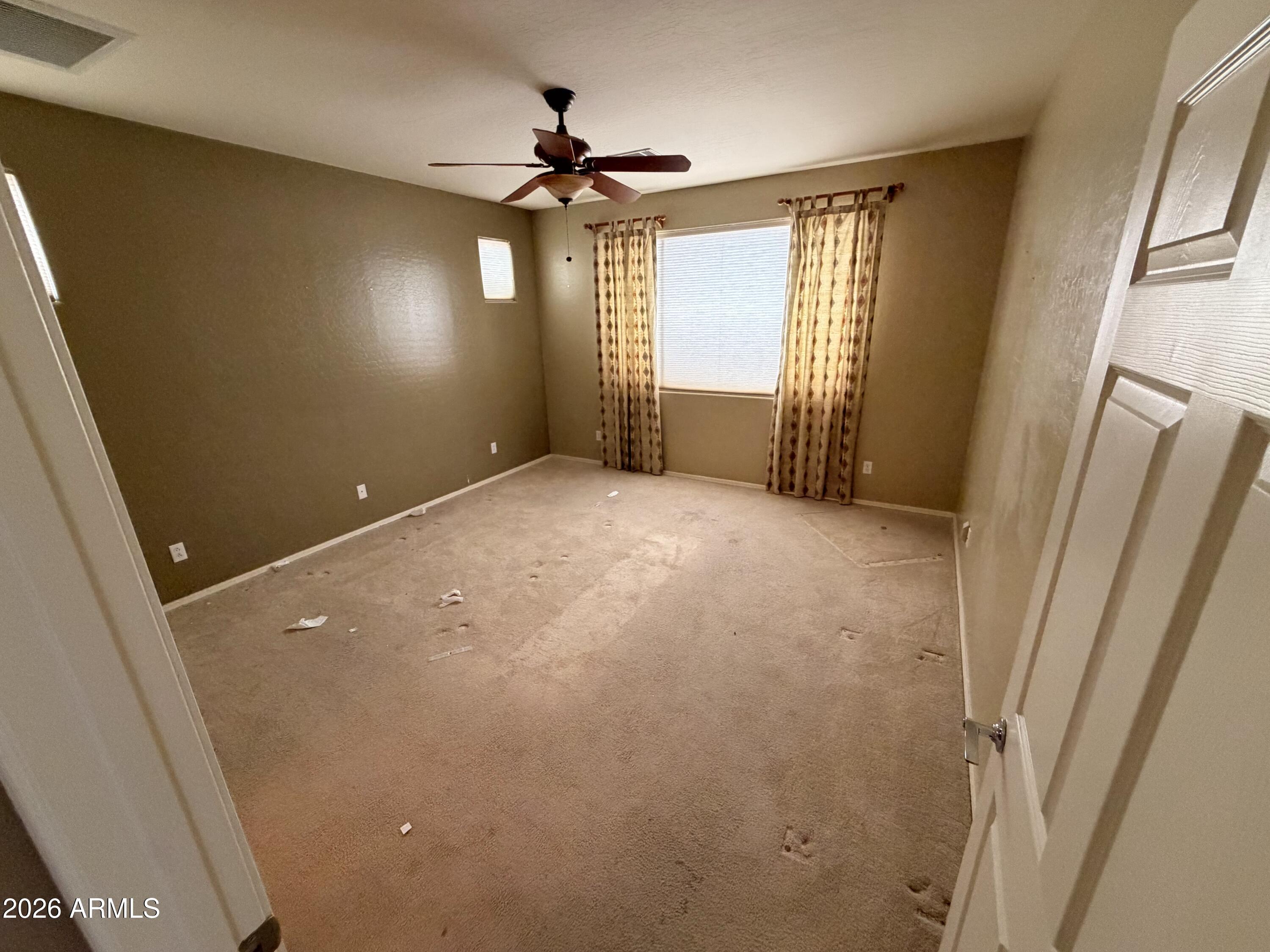 19466 East Reins Road Queen Creek, AZ 85142 - Photo 4 of 10 a view of empty room with wooden floor and fan