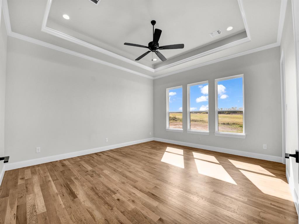 3009 Codigo Drive Weatherford, TX 76088 - Photo 14 of 40 a view of empty room with wooden floor and fan