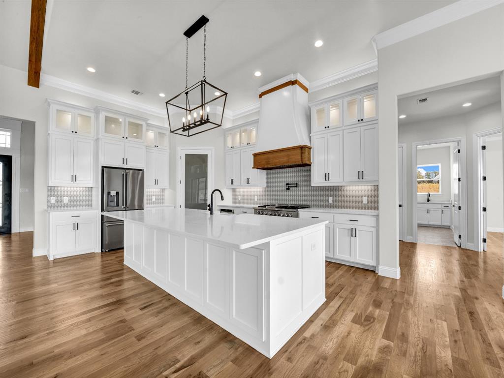 3009 Codigo Drive Weatherford, TX 76088 - Photo 20 of 40 a large kitchen with cabinets a sink a counter space stainless steel appliances and cabinets
