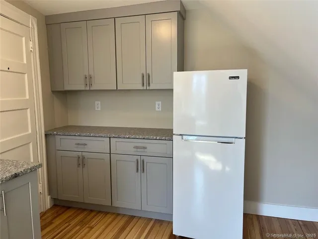 a white refrigerator freezer sitting inside of a kitchen