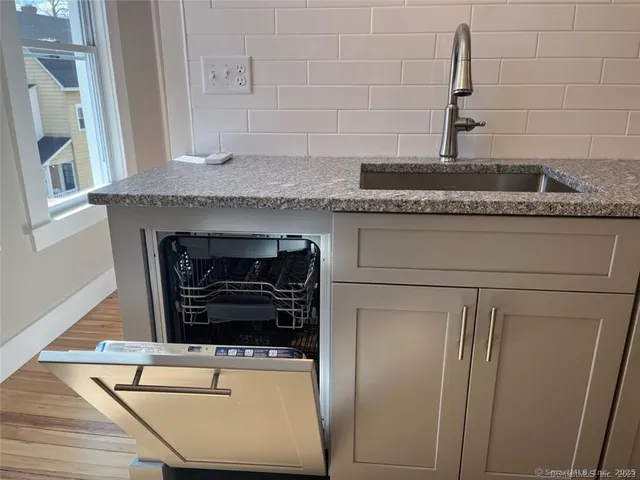 a stove top oven sitting inside of a kitchen
