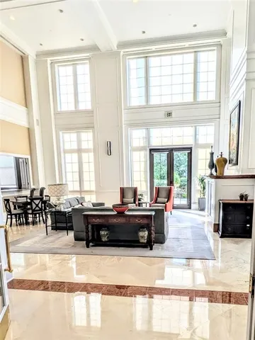 a living room with furniture and large windows