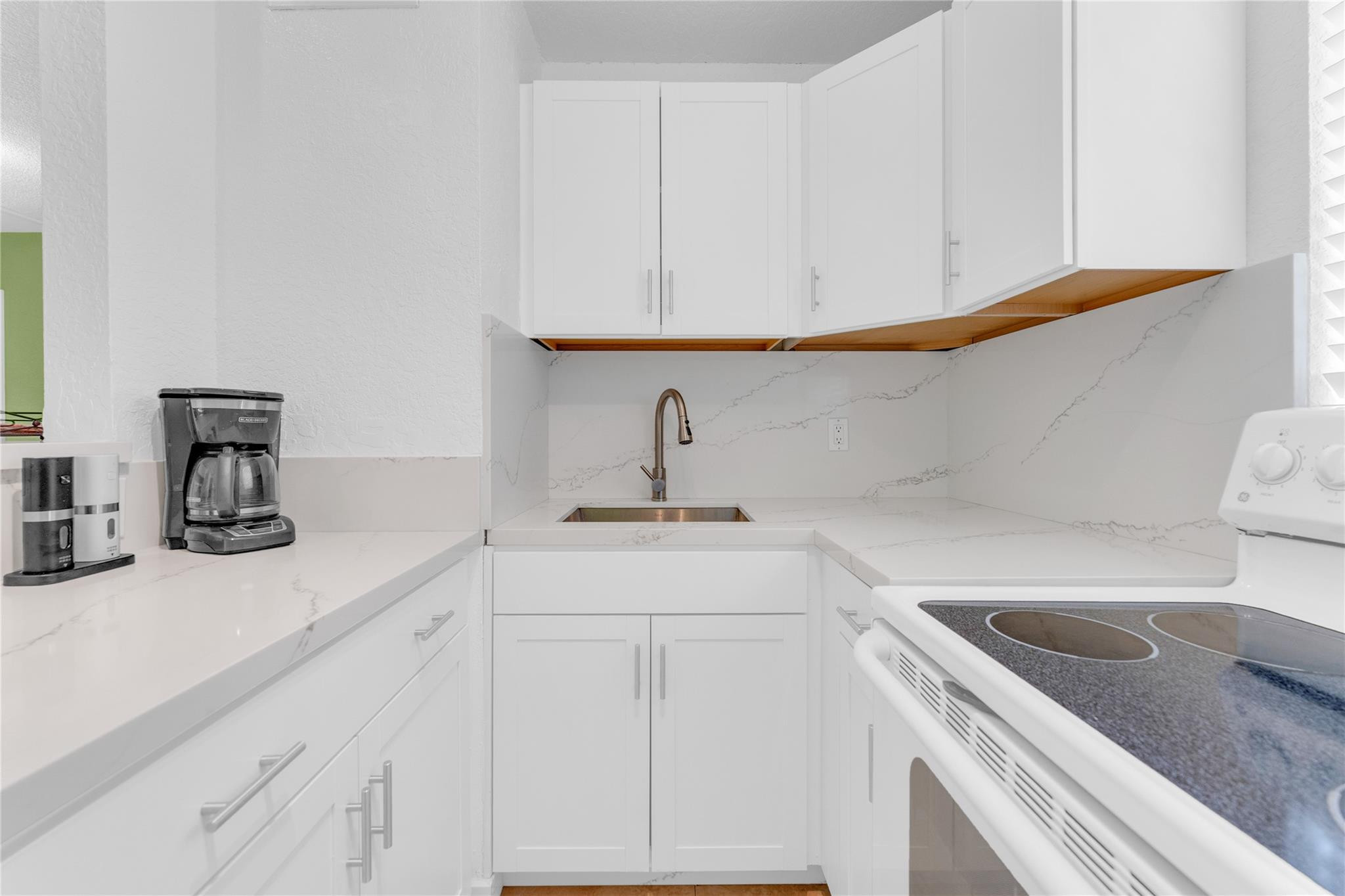 3225 Northeast 16th Street, Unit 10 Pompano Beach, FL 33062 - Photo 14 of 22 a kitchen with a sink and cabinets