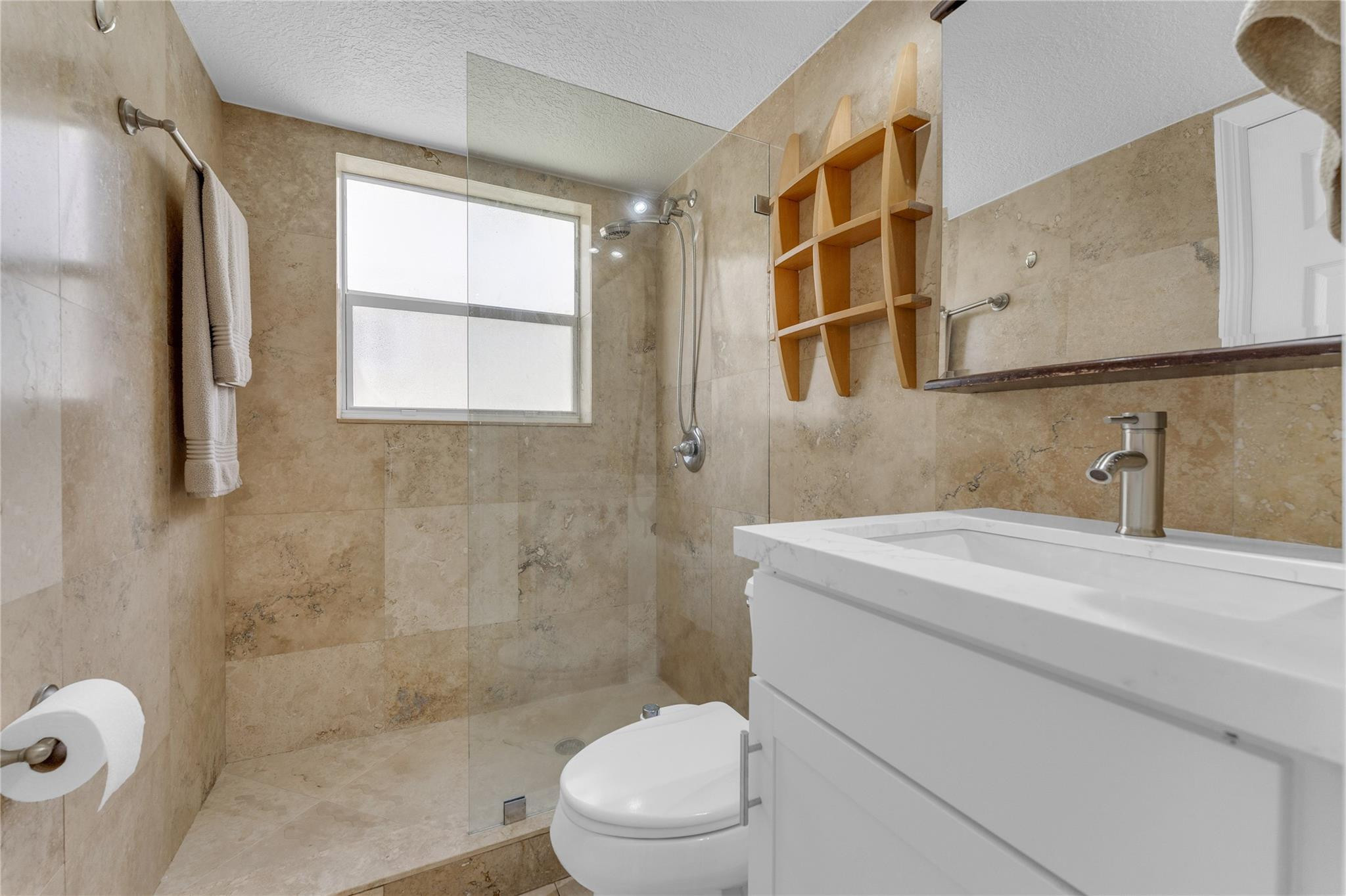 3225 Northeast 16th Street, Unit 10 Pompano Beach, FL 33062 - Photo 18 of 22 a bathroom with a sink a toilet and shower
