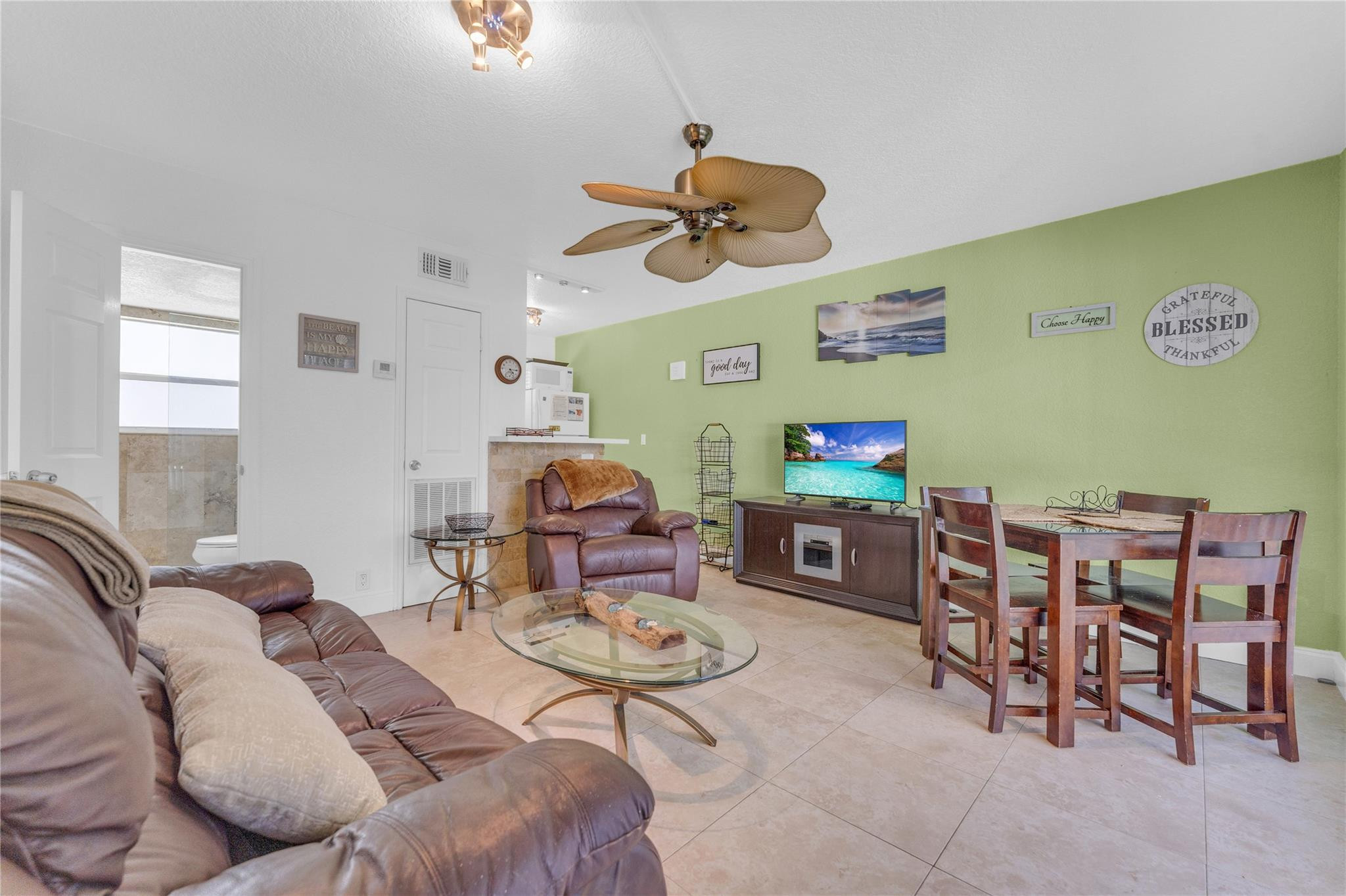 3225 Northeast 16th Street, Unit 10 Pompano Beach, FL 33062 - Photo 9 of 22 a living room with furniture and a flat screen tv