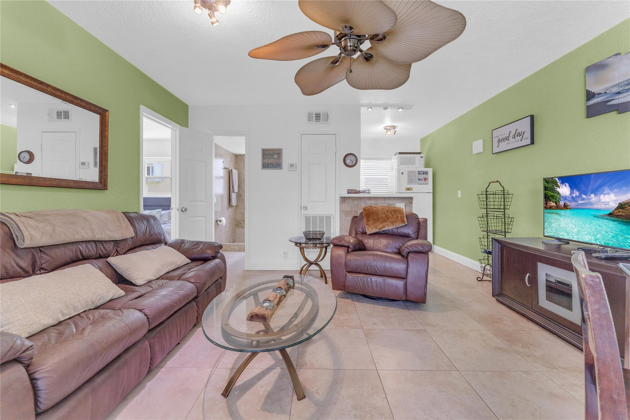 3225 Northeast 16th Street, Unit 10 Pompano Beach, FL 33062 - Photo 10 of 22 a living room with furniture and a flat screen tv
