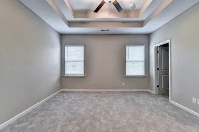 an empty room with windows and closet