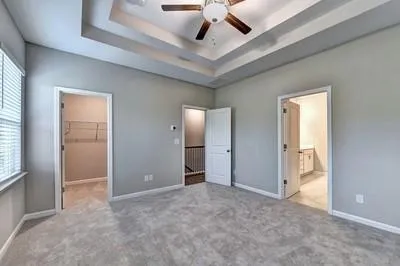 an empty room with fan and windows