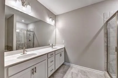 a bathroom with a double vanity sink and a mirror