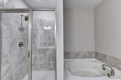a bathroom with a white bath tub and shower