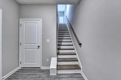 a view of entryway and hall with wooden floor