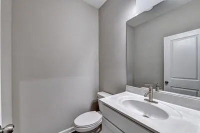 a bathroom with a sink toilet and mirror