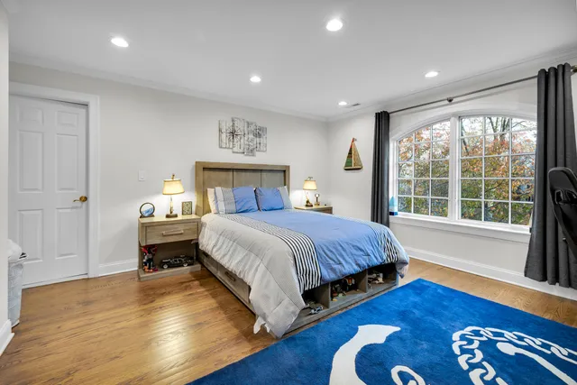 a view of walk in closet with clothes shoes and a view of living room