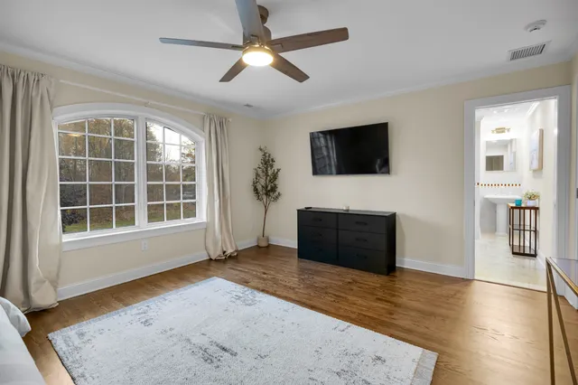 a bedroom with a bed and a large window