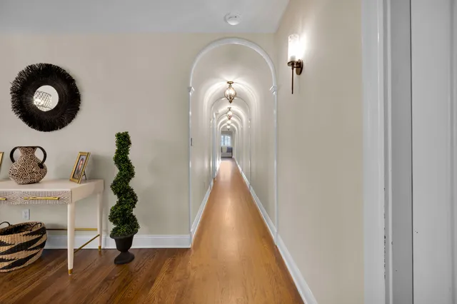 an empty room with windows a fireplace and a flat screen tv
