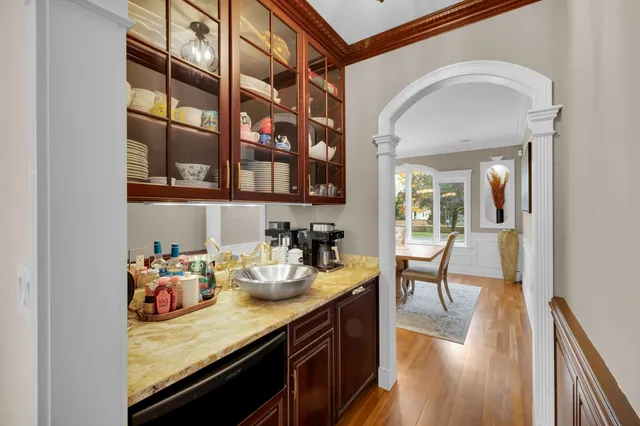 a view of a kitchen area with furniture and wooden floor