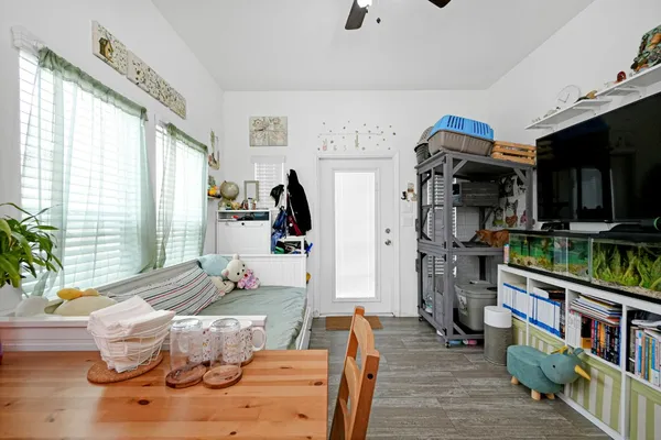 a living room with furniture and a book shelf