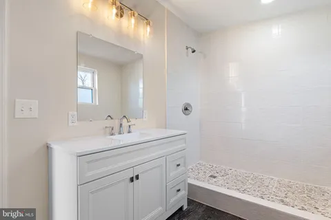 a bathroom with a sink a vanity and a mirror