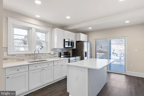 a kitchen with counter top space sink and refrigerator