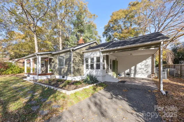 a view of a house with a yard and sitting area