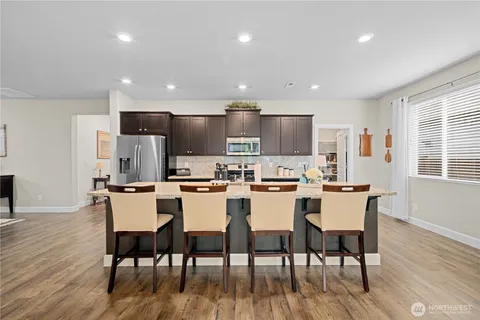a large kitchen with a table and chairs