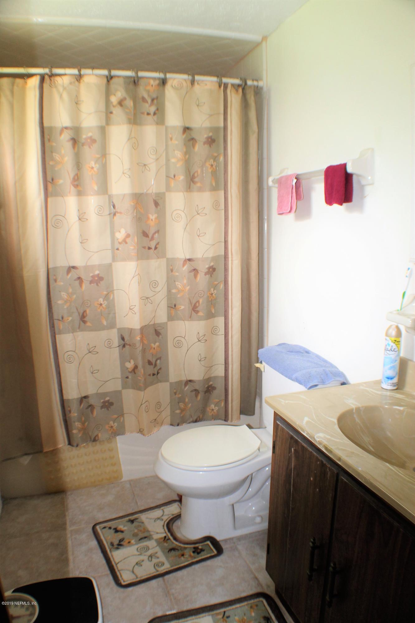 2346 Gayland Road Jacksonville, FL 32218 - Photo 11 of 14 a bathroom with a granite countertop sink a toilet and shower