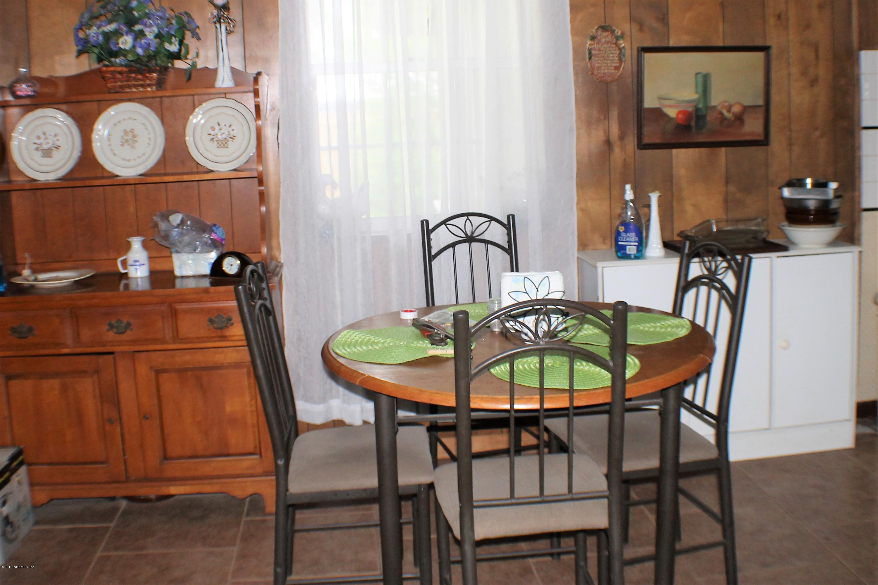 2346 Gayland Road Jacksonville, FL 32218 - Photo 3 of 14 a dining room with furniture and wooden floor