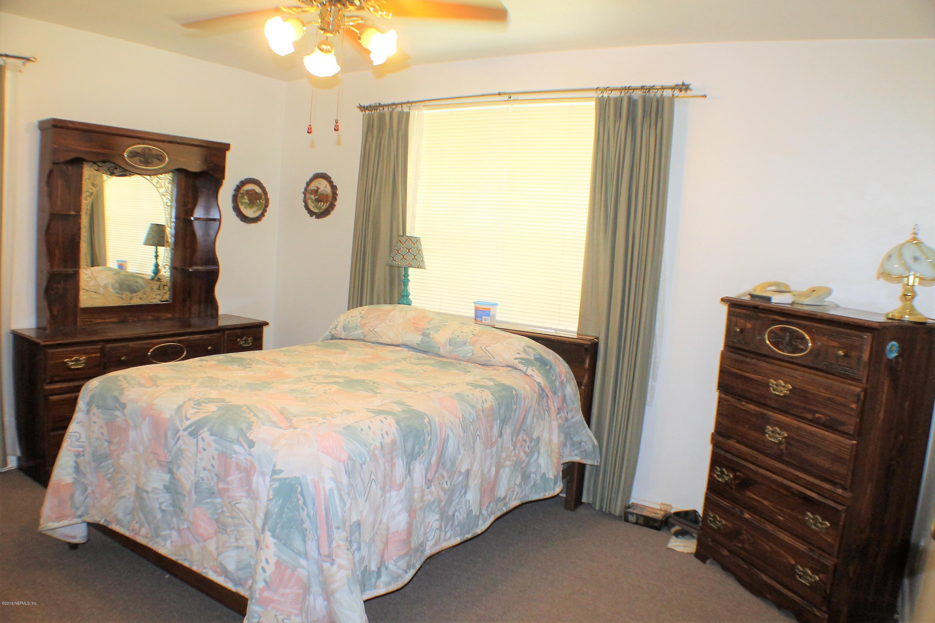 2346 Gayland Road Jacksonville, FL 32218 - Photo 6 of 14 a bedroom with a bed and a mirror