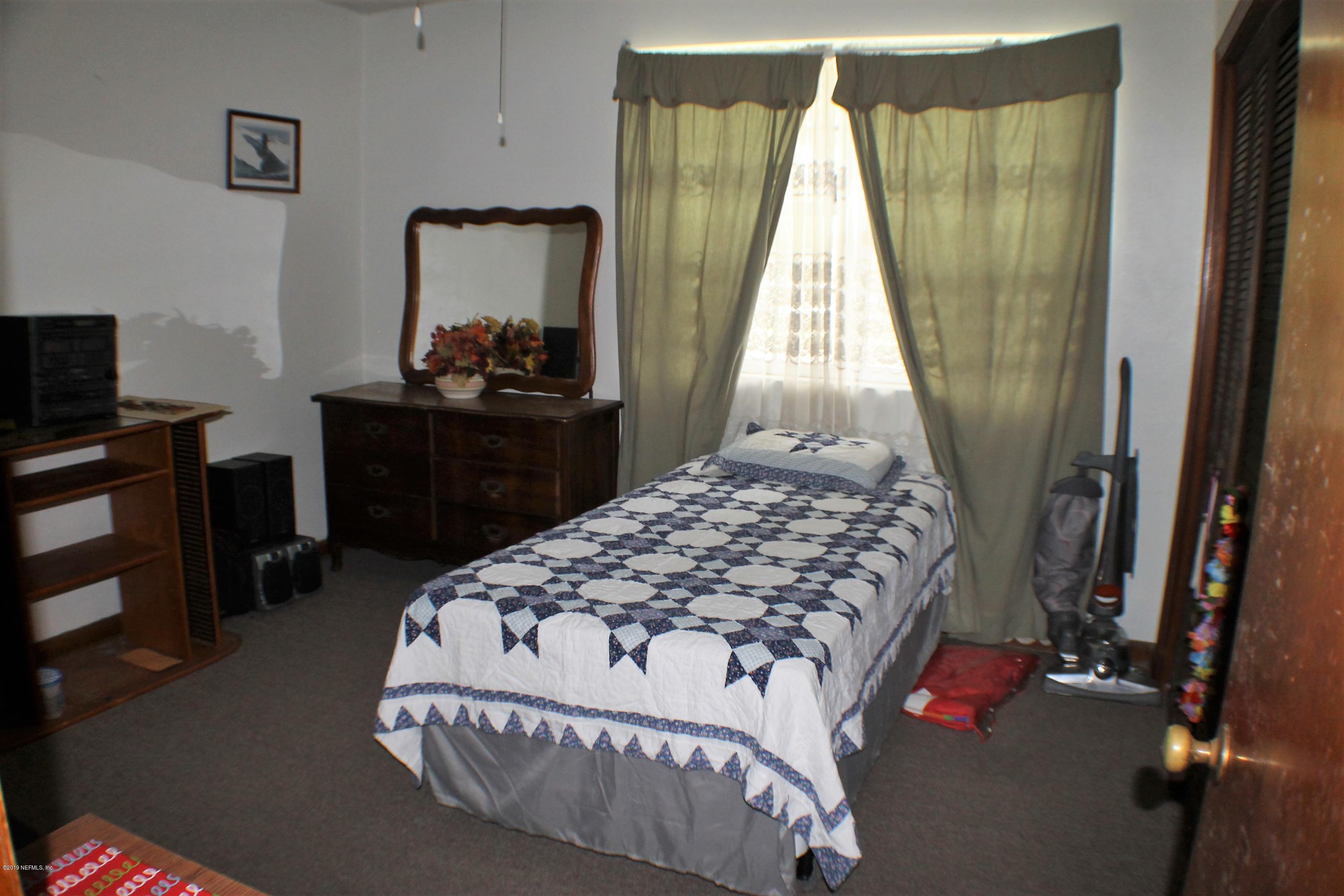 2346 Gayland Road Jacksonville, FL 32218 - Photo 8 of 14 a bedroom with a bed and a flat tv screen on dresser