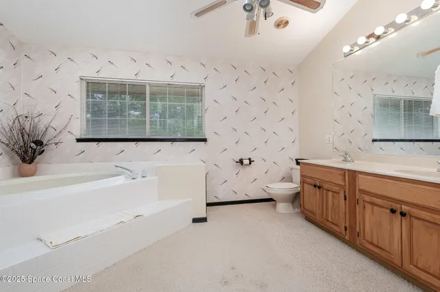 a bathroom with a tub sink and mirror