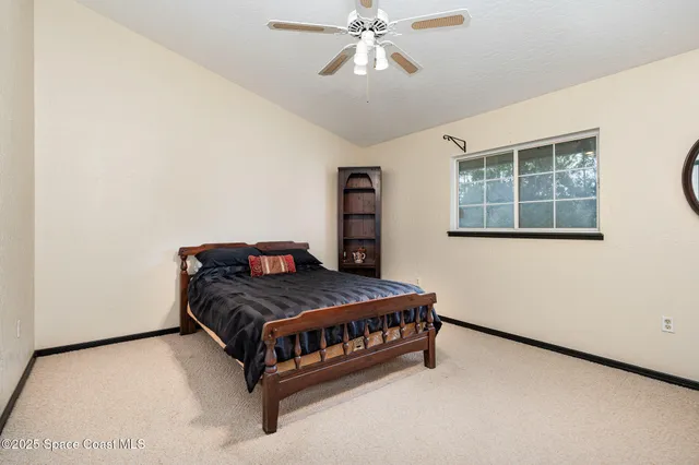 a living room with a bed furniture and a window
