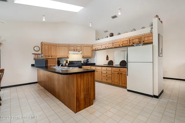 a kitchen with stainless steel appliances a refrigerator and a stove