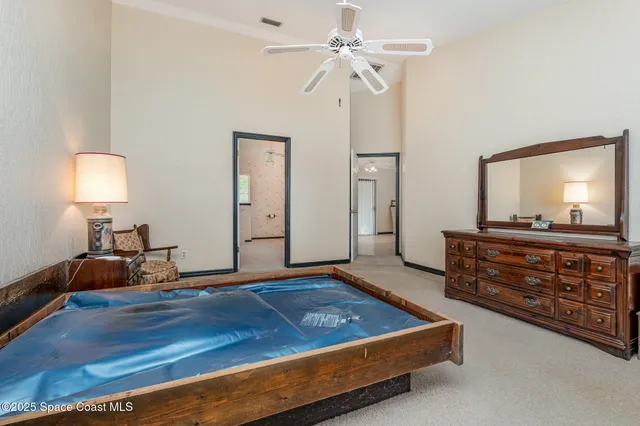 a room with a bed and a dresser