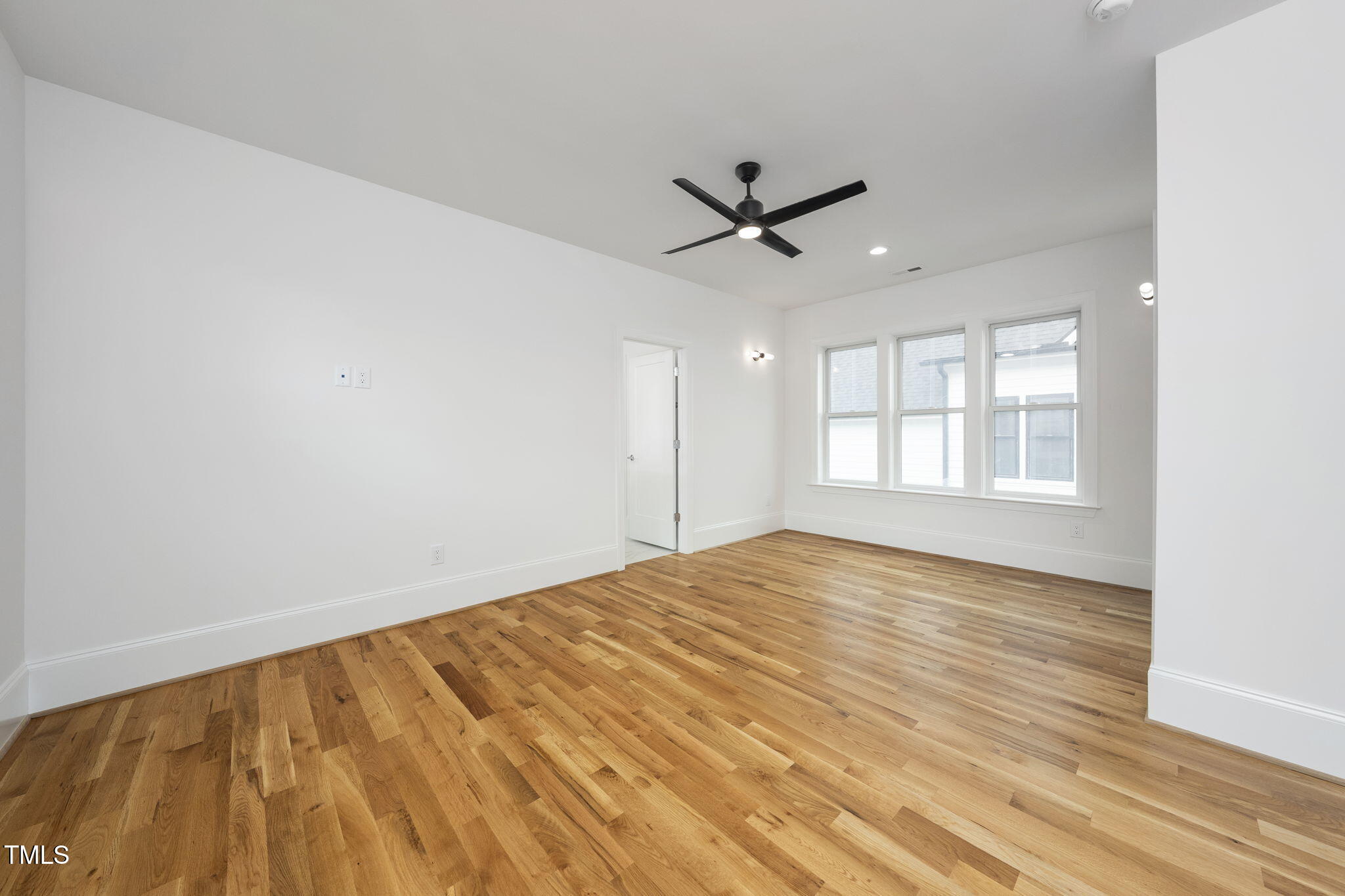 1332 Duplin Road Raleigh, NC 27607 - Photo 36 of 50 a view of empty room with wooden floor and fan