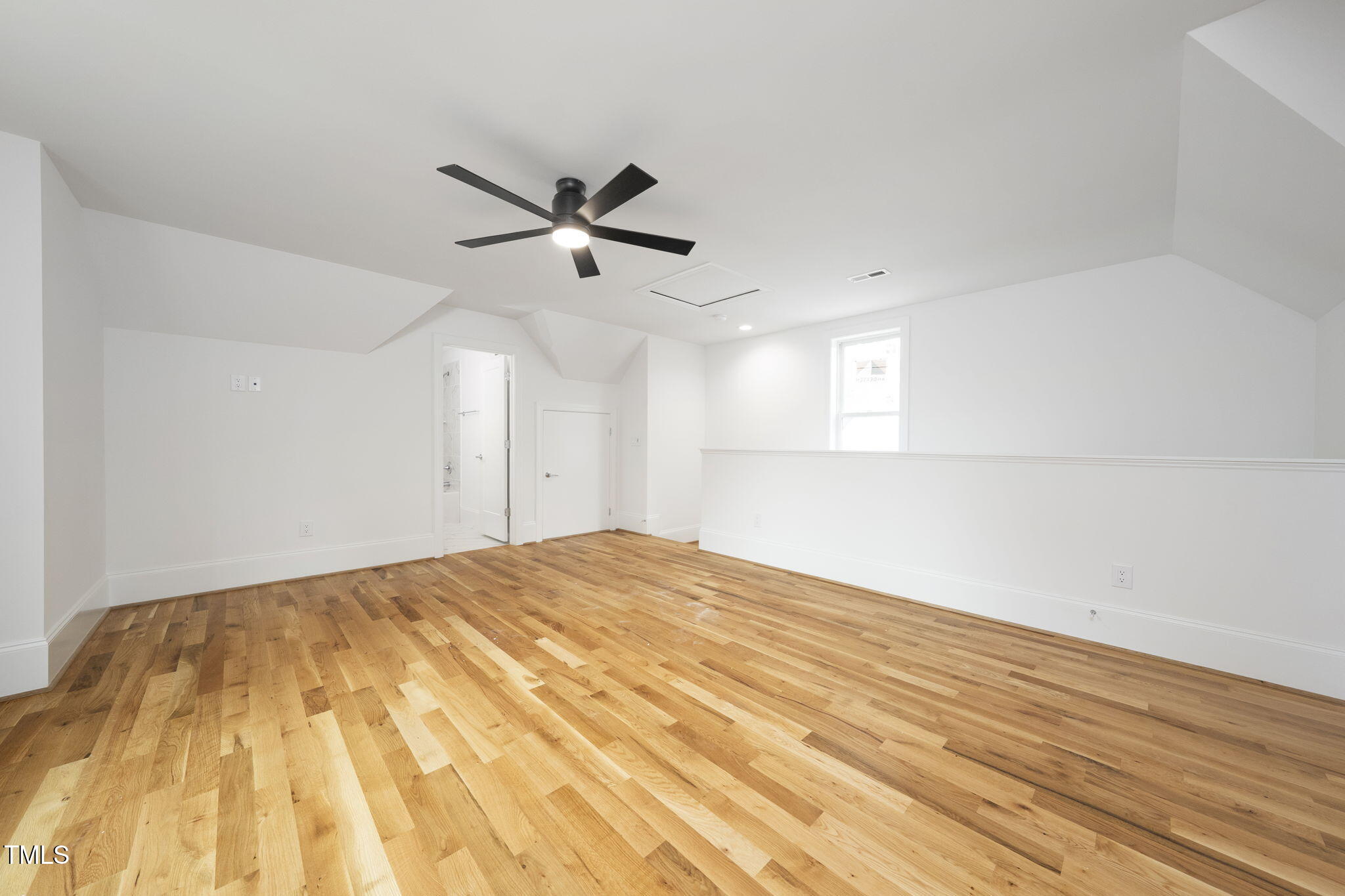 1332 Duplin Road Raleigh, NC 27607 - Photo 45 of 50 a view of a big room with wooden floor and a ceiling fan