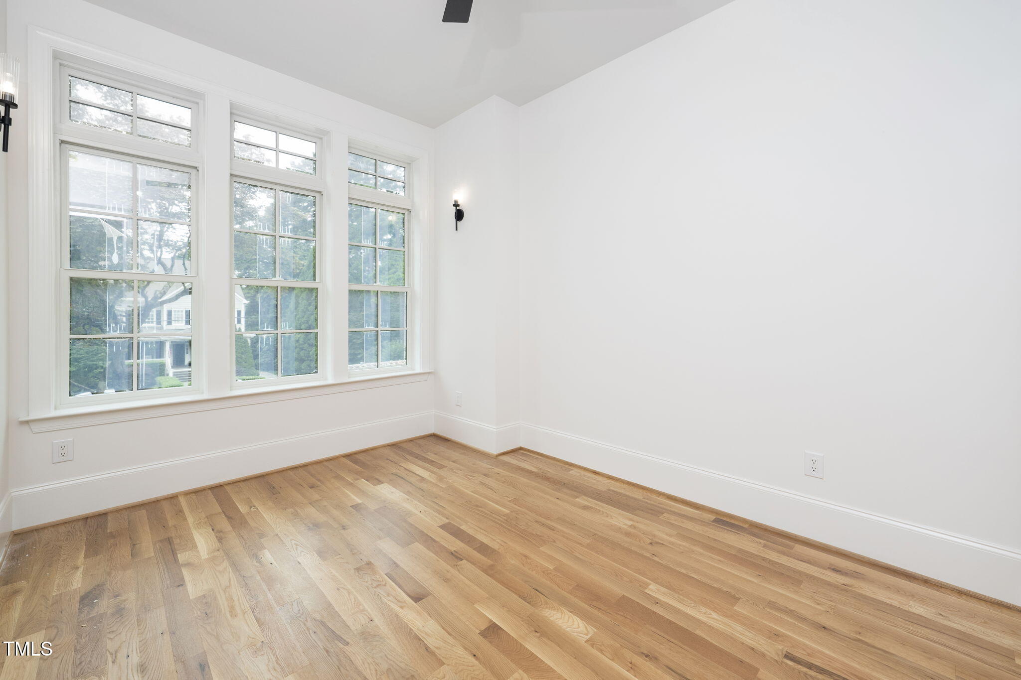 1332 Duplin Road Raleigh, NC 27607 - Photo 9 of 50 a view of an empty room with wooden floor and a window