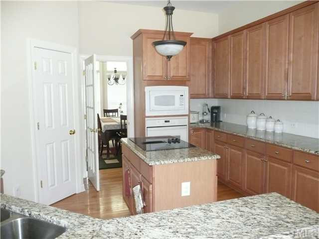 Kitchen newly renovated with granite counter tops, hardware, tile backsplash. Walk-in pantry provides space for all the chef's necessities. Kitchen